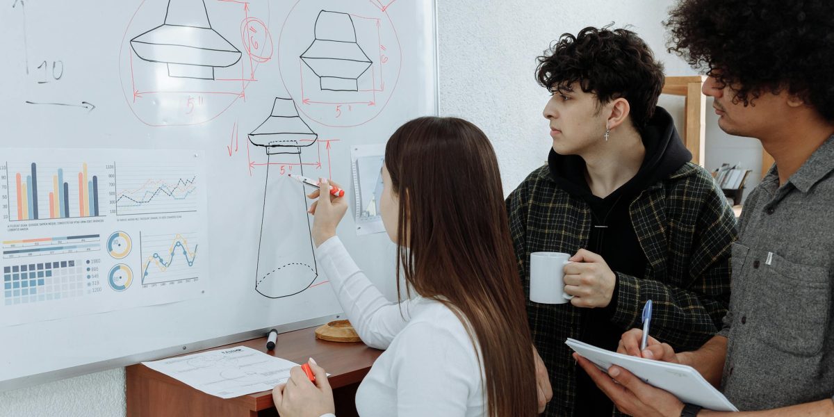 A product team actively collaborating and brainstorming ideas using a whiteboard, fostering innovation and strategy.