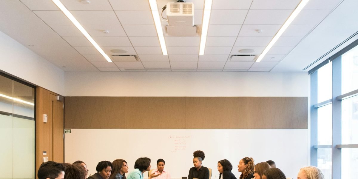 A diverse team engaged in a collaborative discussion, working towards building safer and more reliable AI systems.