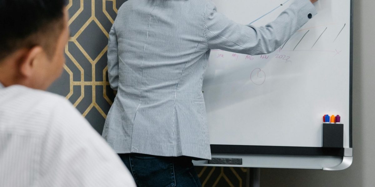 A team actively discussing and planning at a whiteboard, symbolizing strategic decision-making.