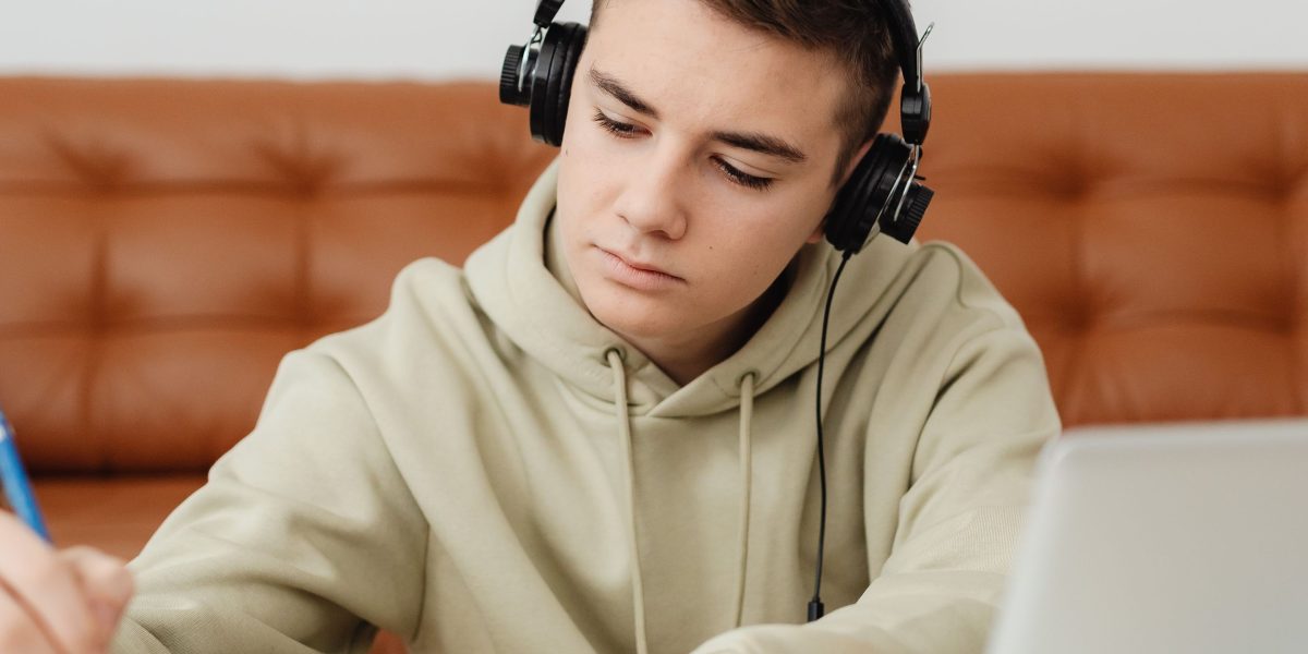 An individual deeply focused on learning new skills through online educational materials.
