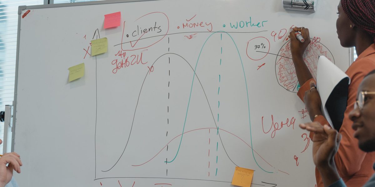 A diverse team collaborating around a whiteboard, emphasizing the importance of soft skills in tech.