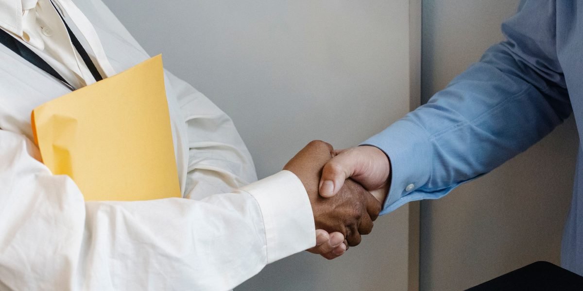 Two professionals shaking hands, symbolizing successful networking and new opportunities.