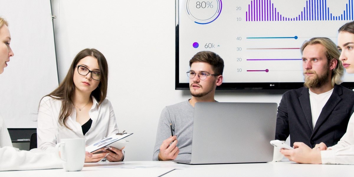 A team engaged in a serious discussion about data security and compliance within an office environment.