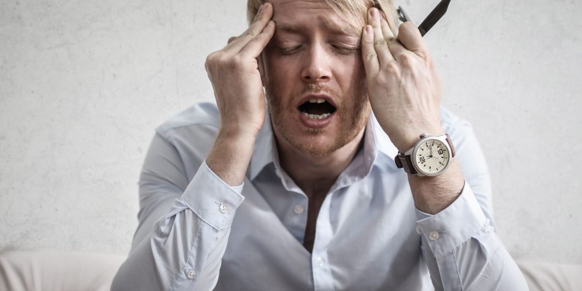 A person appears overwhelmed by a deluge of information, reflecting the challenge of information overload in the fast-paced AI landscape.