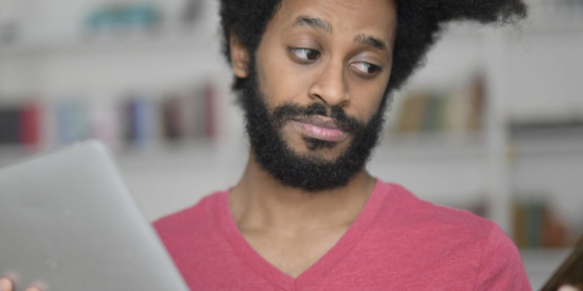 A person reviewing data or documents with a thoughtful expression, representing the enhanced decision-making process with AI assistance.