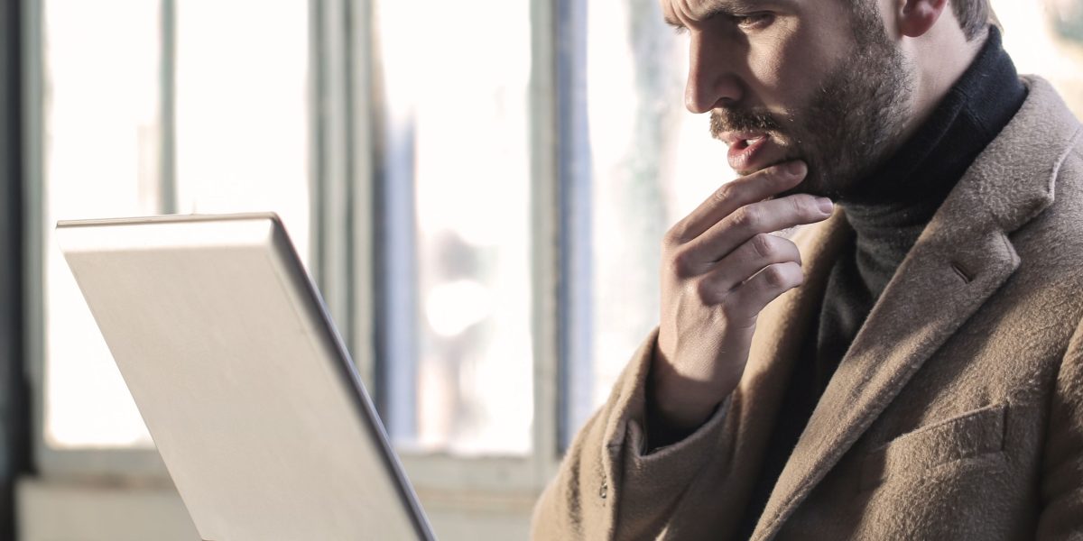 A person deep in thought, representing the careful consideration needed to choose the right AI course.