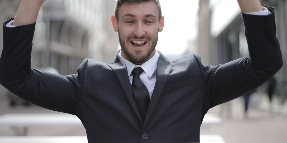 A professional celebrating success, reflecting the positive career outcomes of acquiring AI proficiency.