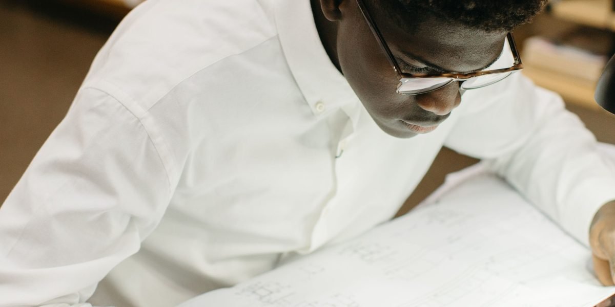 A person thoughtfully plans their academic and career future, evaluating choices.