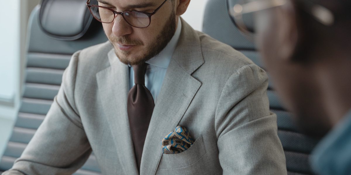 A manager thoughtfully considering the integration of AI into their company's hiring process, weighing potential benefits and risks.