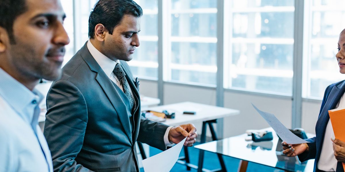 Professionals engaged in a serious discussion, likely about the ethical implications and fairness of AI in hiring.