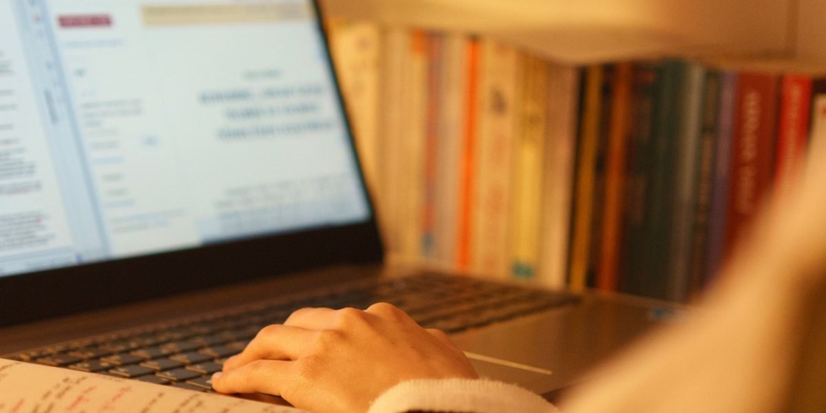 A person intently studying on a laptop, symbolizing the continuous learning required for developers to stay current with new AI technologies.