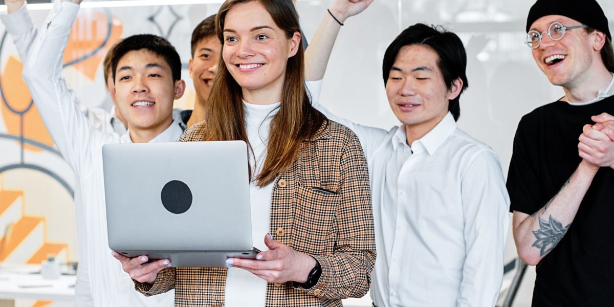A group of professionals celebrating a successful outcome, reflecting the positive impact and ROI from effective AI learning platform implementation.