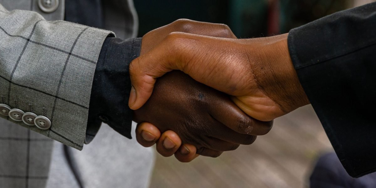 Two professionals shaking hands after a meeting, symbolizing successful networking and collaboration.