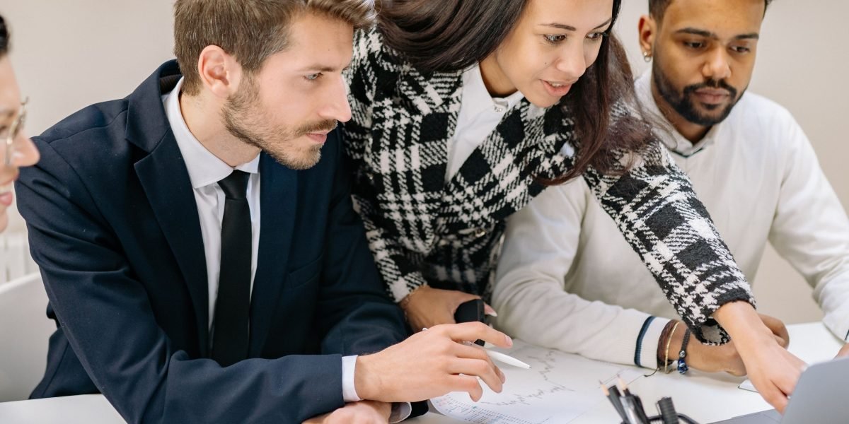Professionals collaborate around a whiteboard, strategizing how to integrate AI capabilities into their development workflows and long-term project roadmaps.