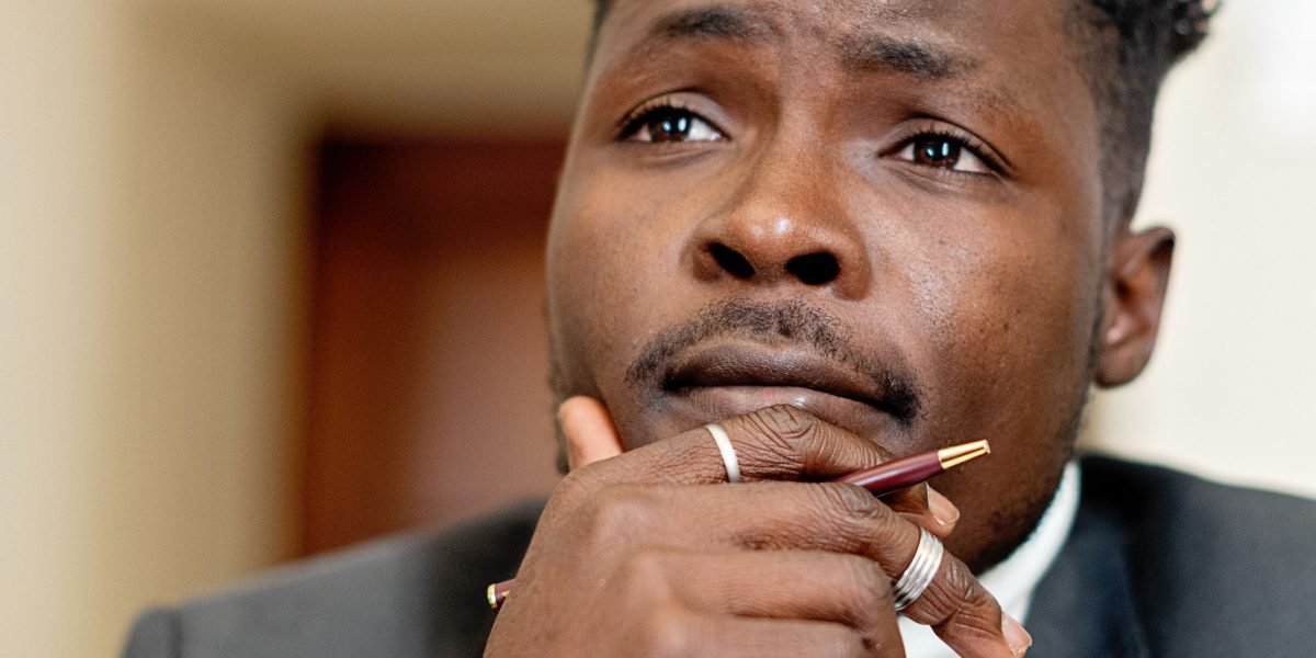 A person deep in thought, contemplating their career path and the potential of becoming their own boss.