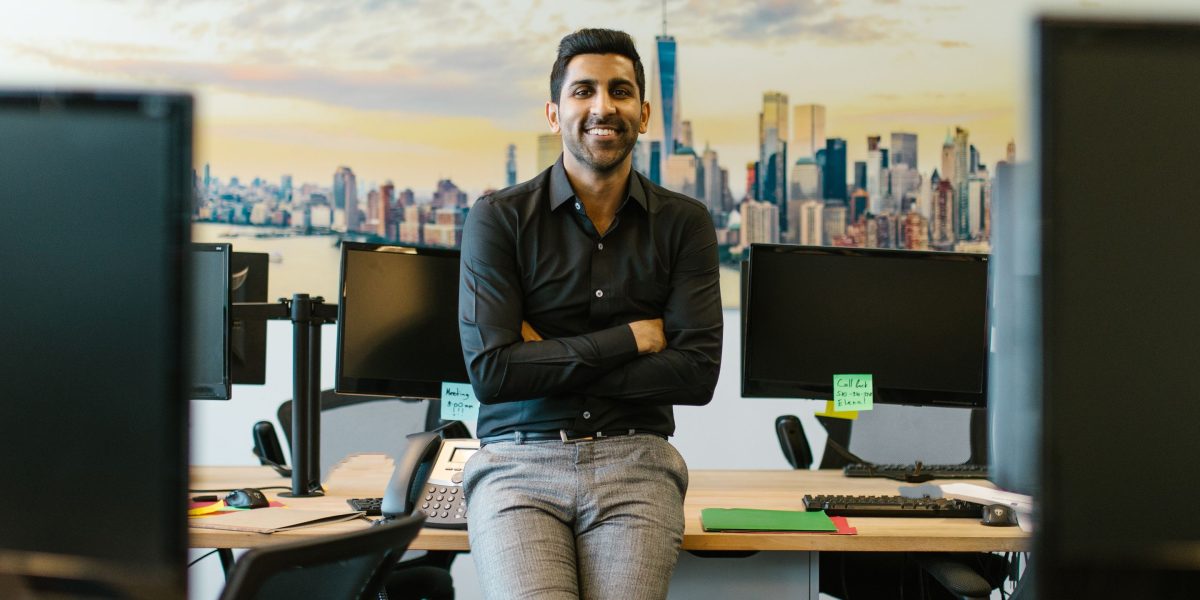 A confident individual smiling in a professional setting, having found their ideal career path.