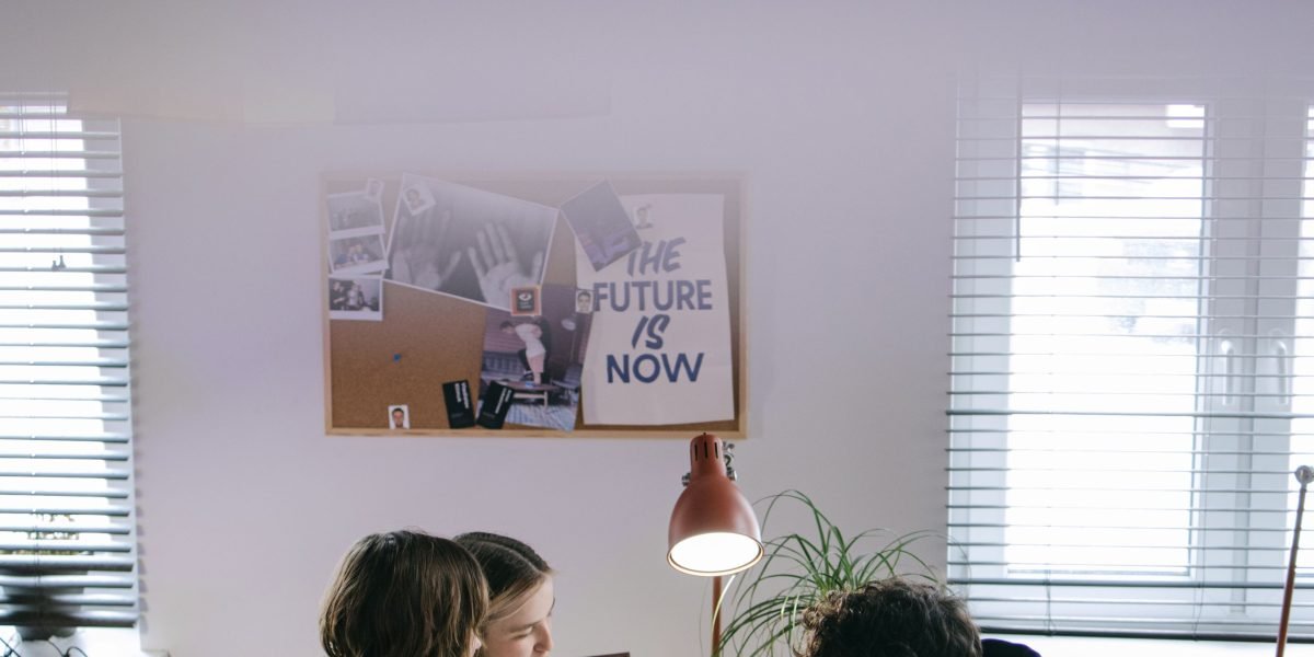 A small team collaborating effectively in an office environment, representing the growth from a solo freelancer to a consultancy.