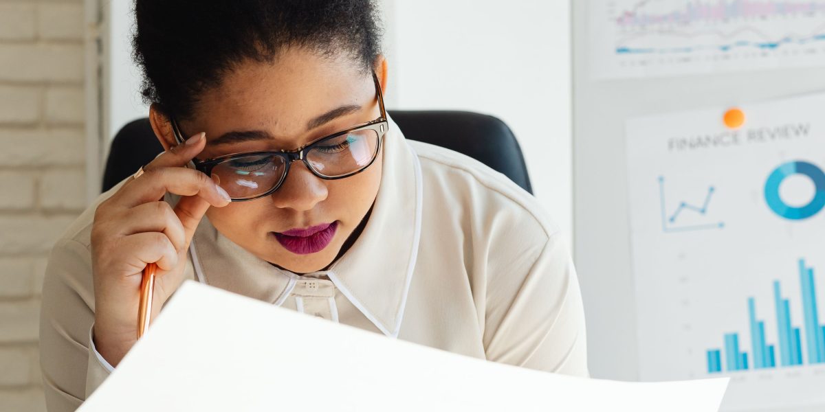 An executive thoughtfully reviewing documents, symbolizing the crucial step of assessing company readiness before developing an AI roadmap.