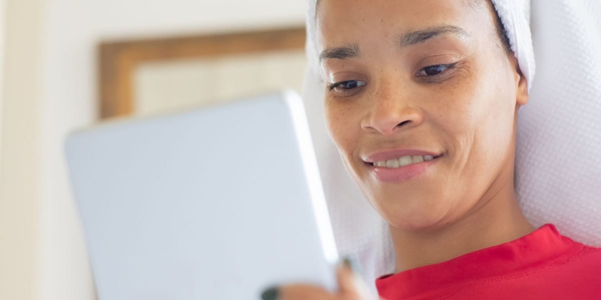 A person intently reading news on a tablet, symbolizing the importance of staying informed in the fast-paced tech world.