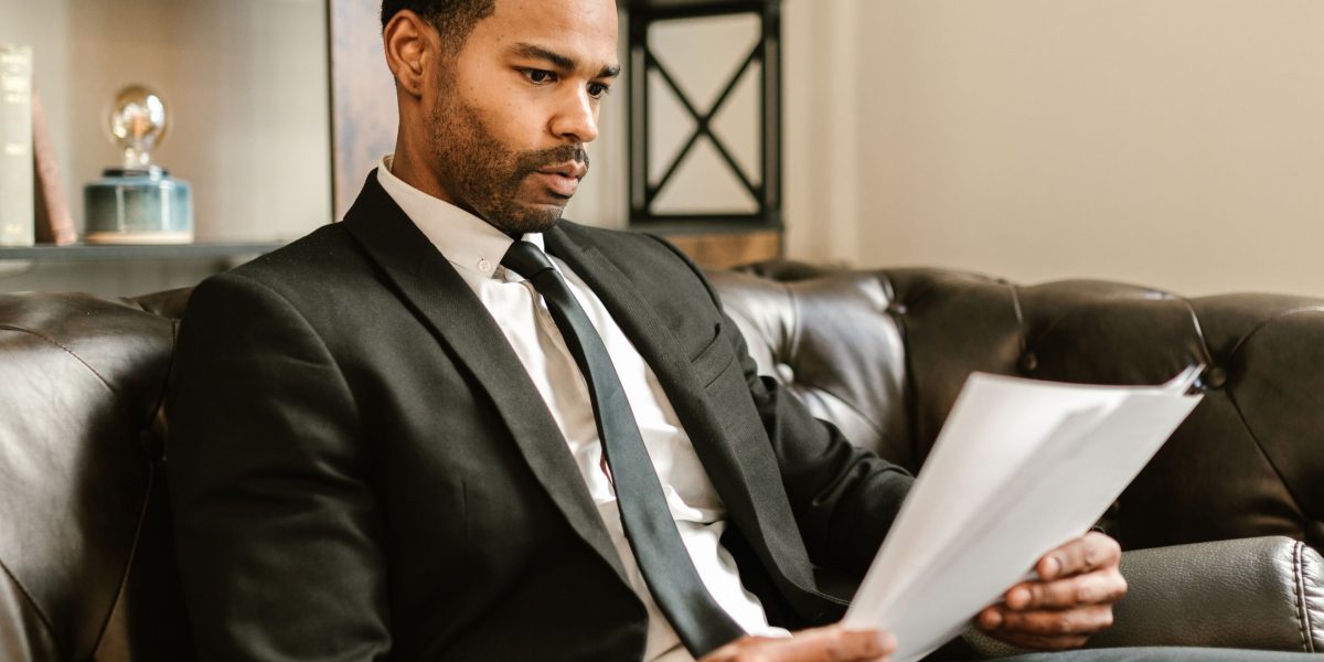 A focused individual carefully reviewing documents, symbolizing the critical attention to security, privacy, and compliance in enterprise development.