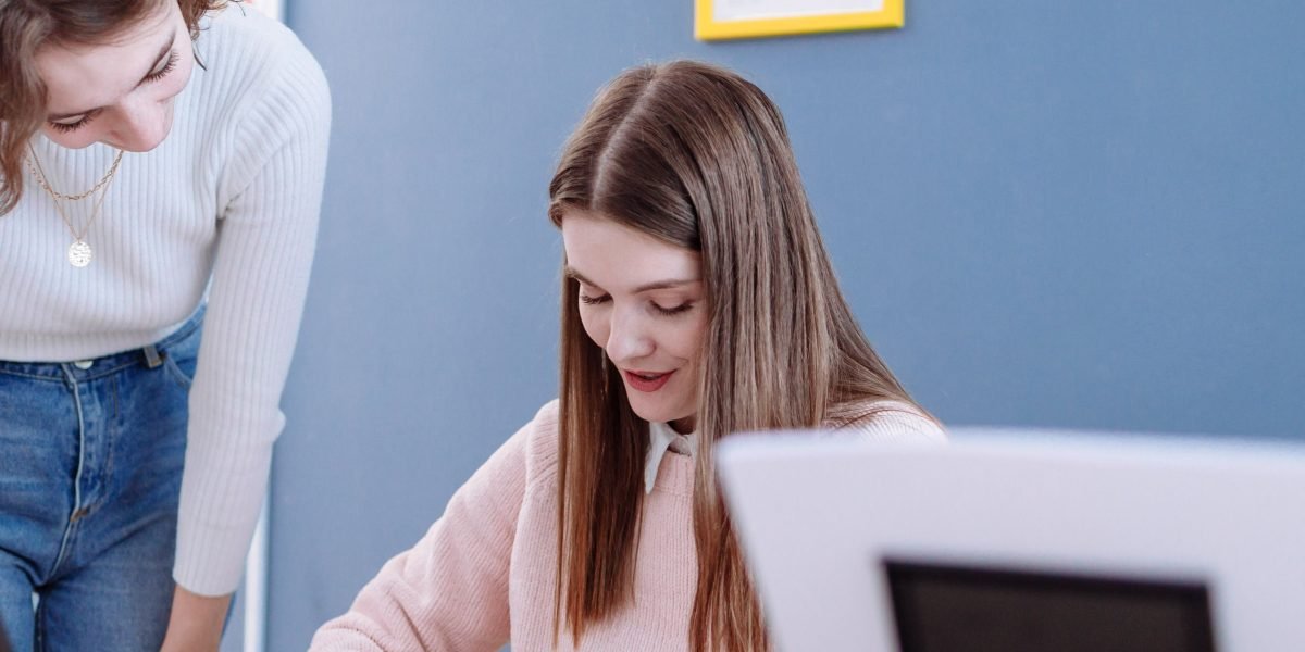 An experienced professional provides guidance and advice to a student or mentee in a friendly discussion setting.