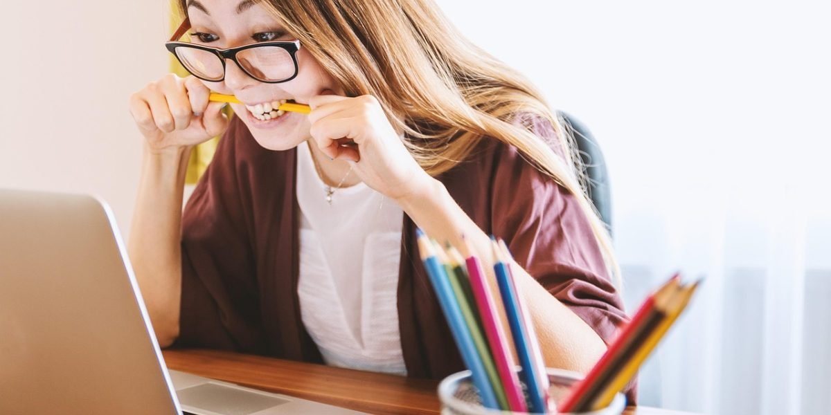 An individual engaged in online learning from a home setting, demonstrating self-discipline.