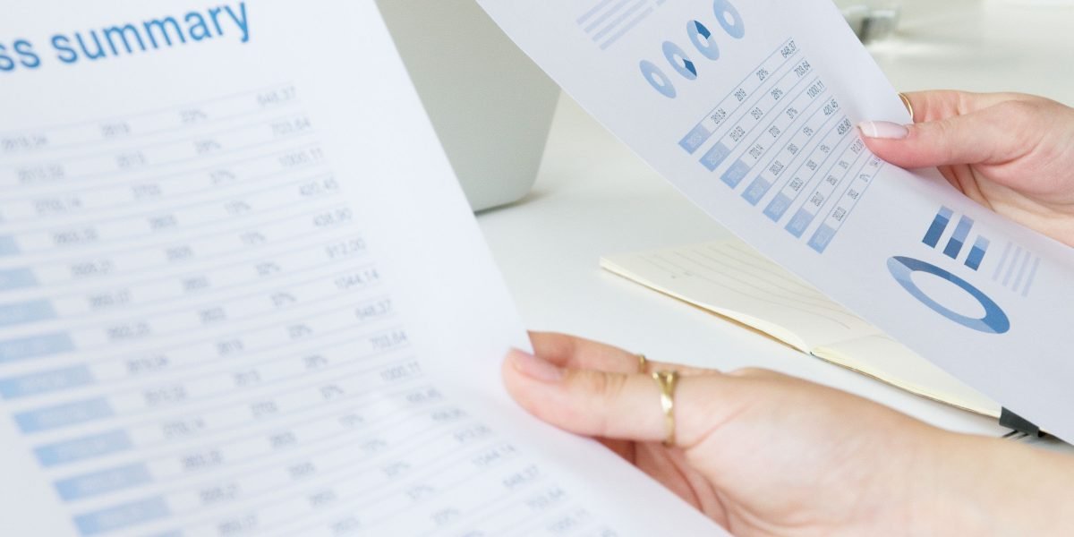 Professionals carefully analyzing data and reports to assess the performance and value of AI systems.