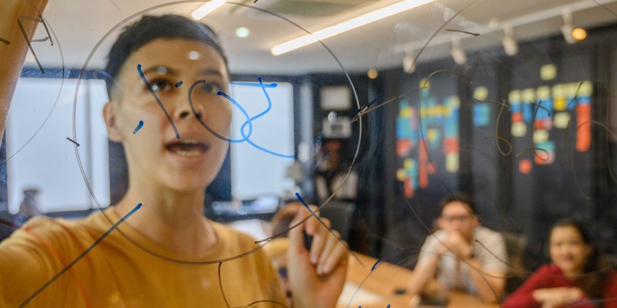 A person deep in thought, working through a complex problem, reflecting the critical thinking required for algorithmic design.