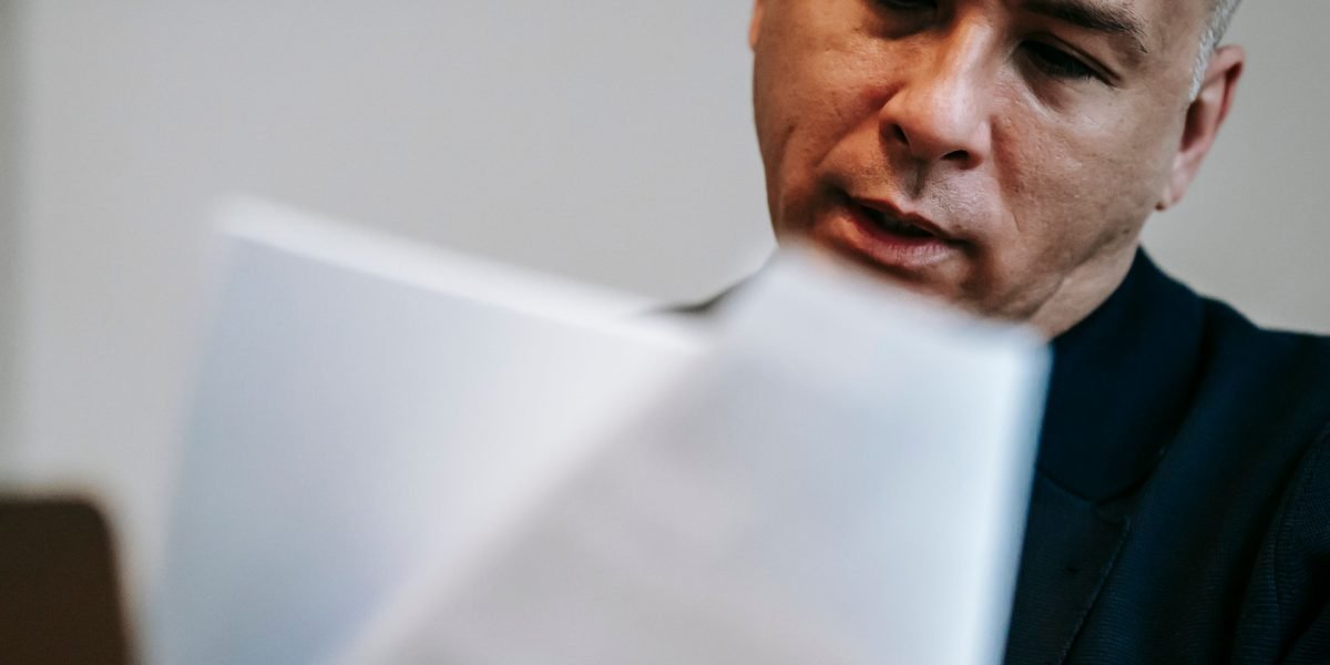 A professional reviewing documents, representing the crucial step of checking client references for vendor evaluation.