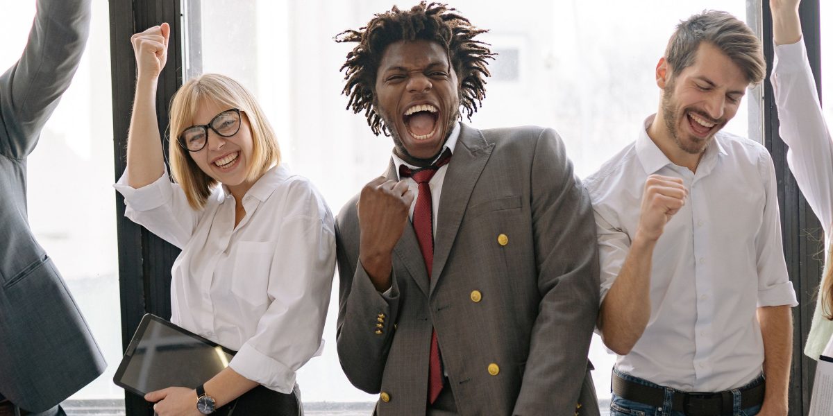 A team celebrates the successful implementation and positive impact of new AI tools on their workflow.