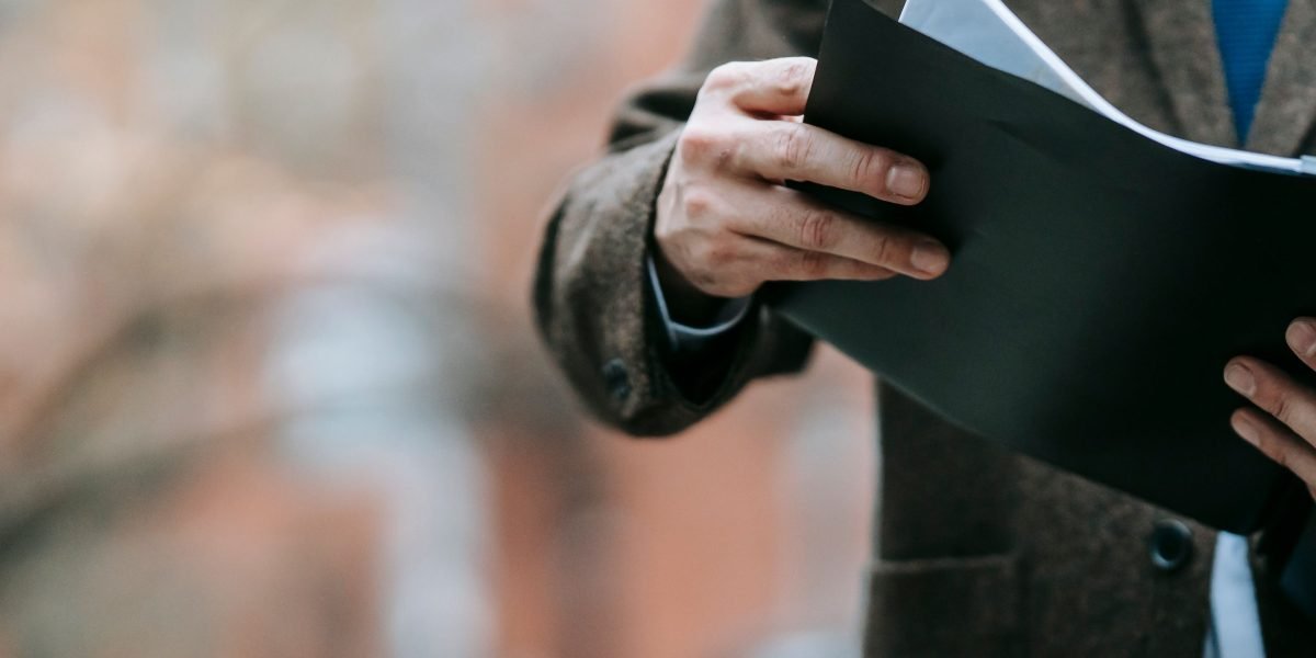 A professional diligently examining documents, symbolizing the importance of security and compliance reviews.