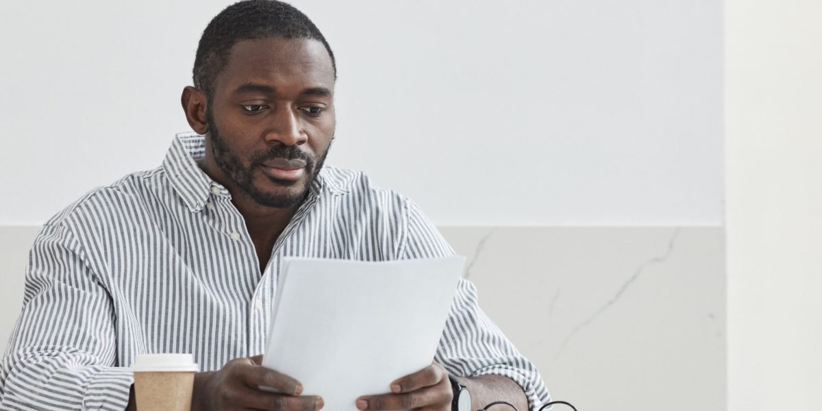 An individual focused on analyzing strategic documents, reflecting on personal and team skill development.