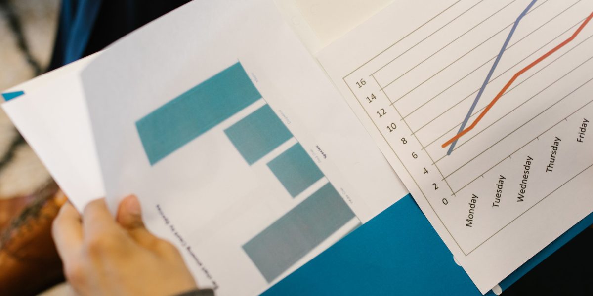 A team thoughtfully reviews charts and data, representing the critical analysis of KPIs to measure beta engineering success.
