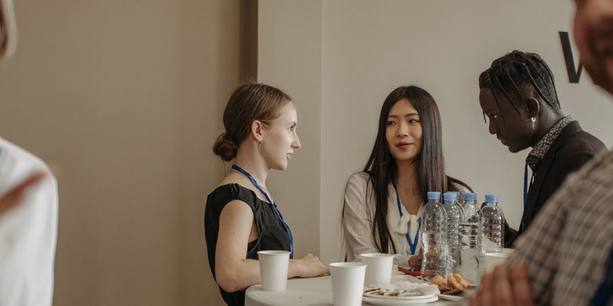 A group of colleagues engaged in an informal learning session, such as a 'lunch-and-learn'.