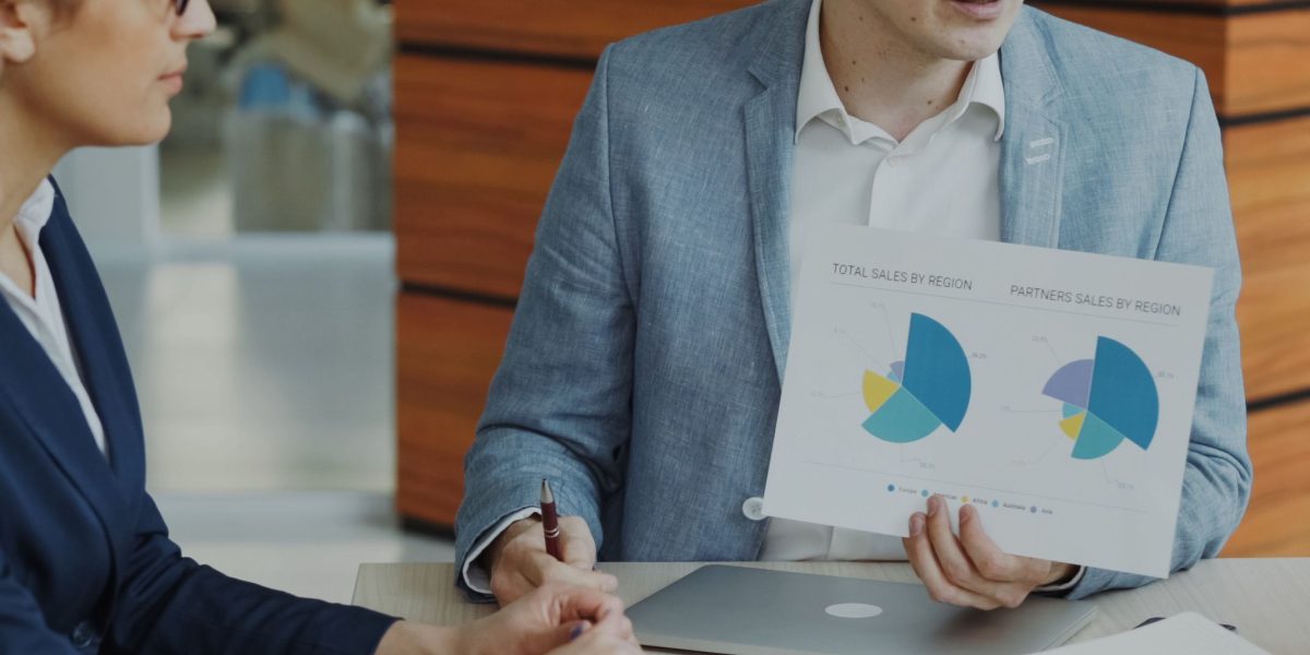 A professional presenting their project portfolio, demonstrating their specialized skills and past work to a potential client.
