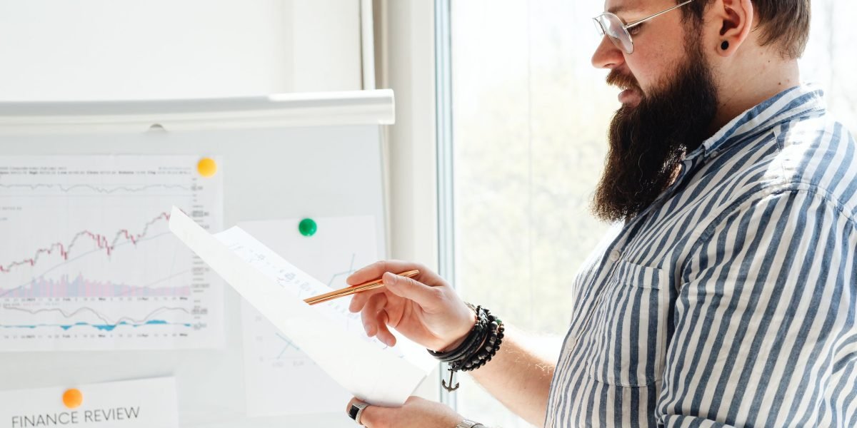 A person intently analyzing data charts on a computer, representing the process of measuring AI tool productivity and ROI.